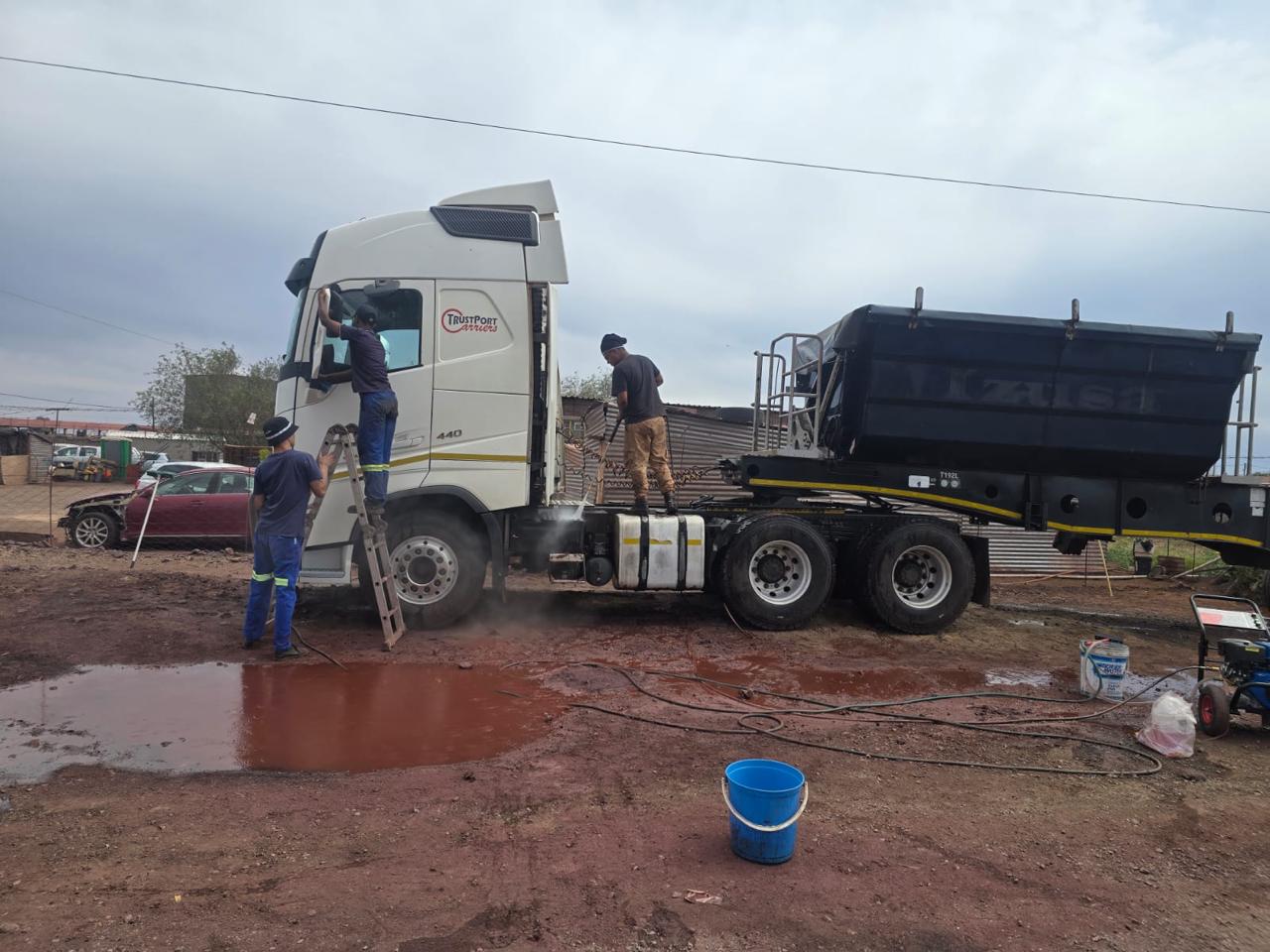 LLH Projects team cleaning a white truck and trailer